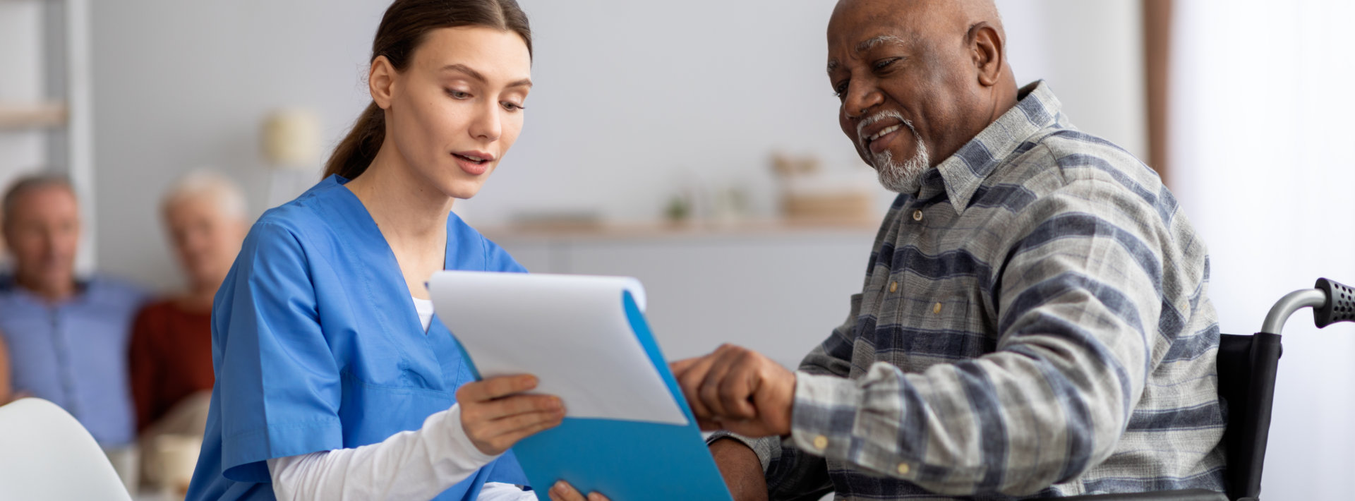caregiver and senior checking medical list