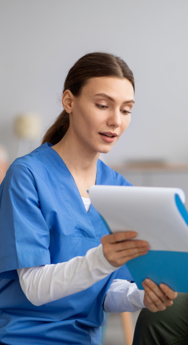 caregiver and senior checking medical list